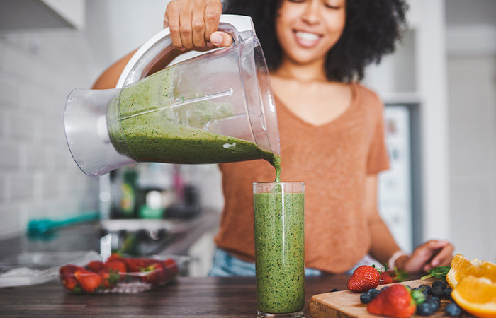 woman making a smoothie