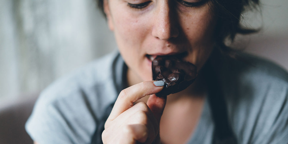woman eating dark chocolate