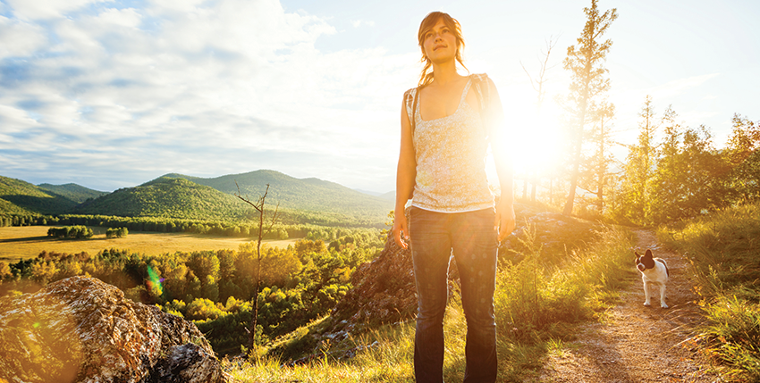 woman hiking with her dog